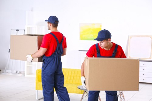 Movers preparing for a London home removal with boxes and furniture