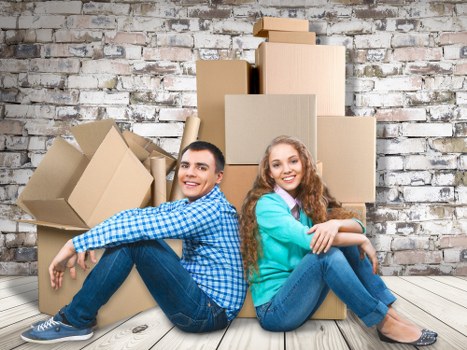 Unpacking boxes in a new London flat to help a customer settle in
