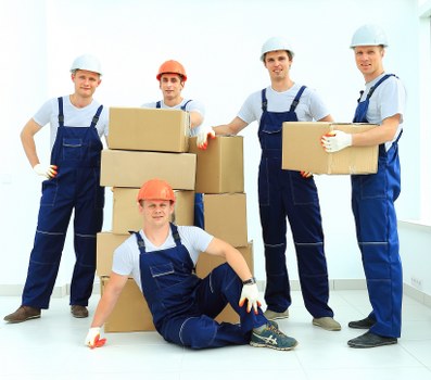 Removal team loading boxes and furniture for a London house move