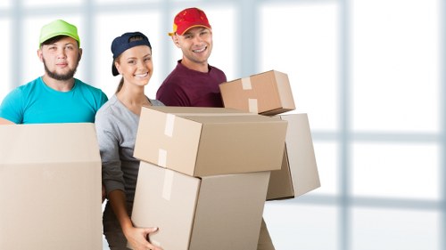 Removal team managing a residential move in London with boxes and furniture