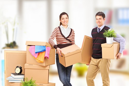 Helpers loading boxes and furniture into a truck