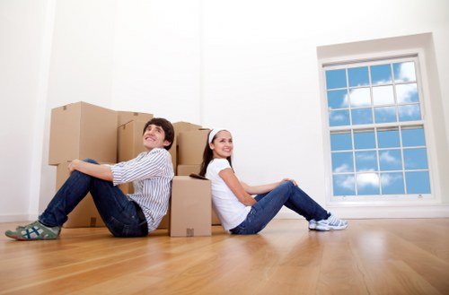 Relocation crew moving office furniture through a London building