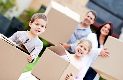 Professional removal crew handling furniture in a London apartment building