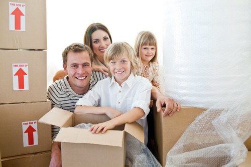 Movers carrying furniture through a London apartment building